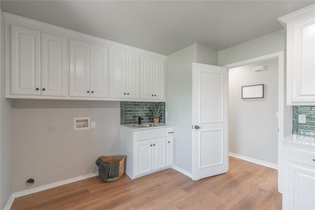 1848 County Road 1198, Tuttle, OK 73089 - laundry area with hookup for a washing machine, light wood finished floors, and cabinet space