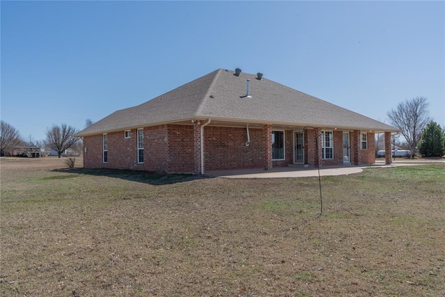 1848 County Road 1198, Tuttle, OK 73089 - back of house featuring a lawn, brick siding, and a patio area