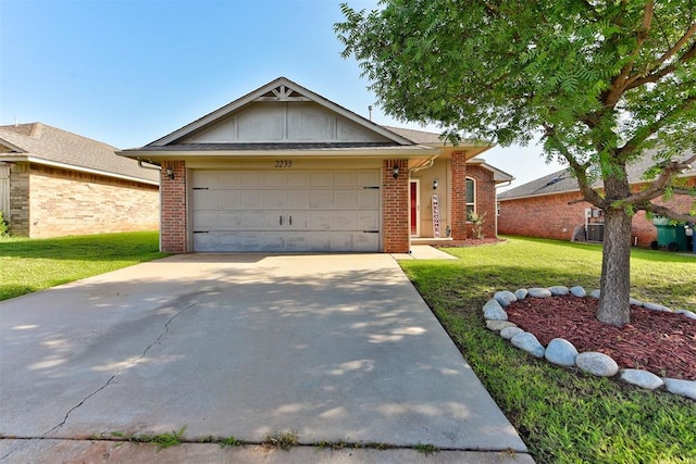 2233 NW 196th St, Edmond, OK 73012 - ranch-style home featuring a front lawn, driveway, an attached garage, and brick siding
