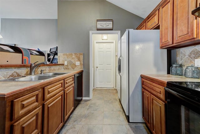 2233 NW 196th St, Edmond, OK 73012 - kitchen with black range with electric stovetop, backsplash, dishwashing machine, brown cabinets, and freestanding refrigerator