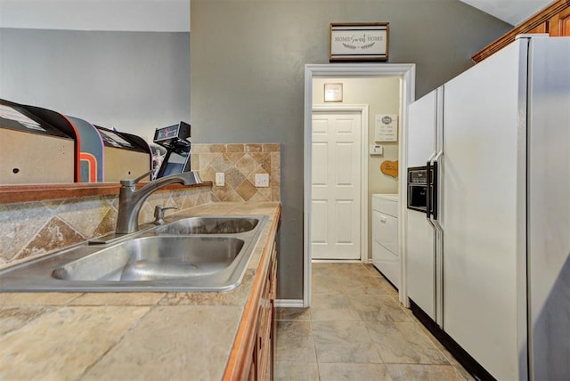 2233 NW 196th St, Edmond, OK 73012 - kitchen with white fridge with ice dispenser, washer / clothes dryer, and light countertops