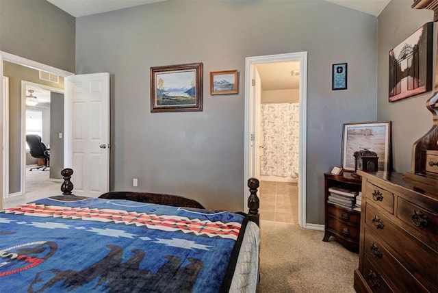2233 NW 196th St, Edmond, OK 73012 - bedroom with light carpet, connected bathroom, and lofted ceiling