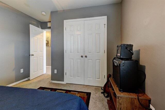 2233 NW 196th St, Edmond, OK 73012 - carpeted bedroom featuring a closet and baseboards