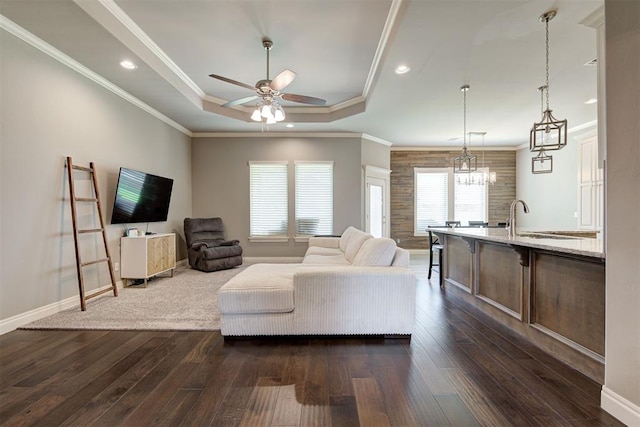 4600 Kentucky Ridge Dr, Mustang, OK 73064 - living area with dark wood-type flooring, a tray ceiling, a ceiling fan, recessed lighting, and ornamental molding