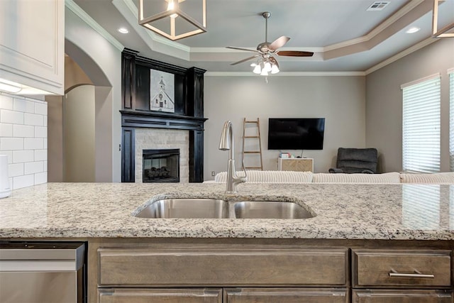 4600 Kentucky Ridge Dr, Mustang, OK 73064 - kitchen with dishwasher, ceiling fan, ornamental molding, backsplash, and a tray ceiling