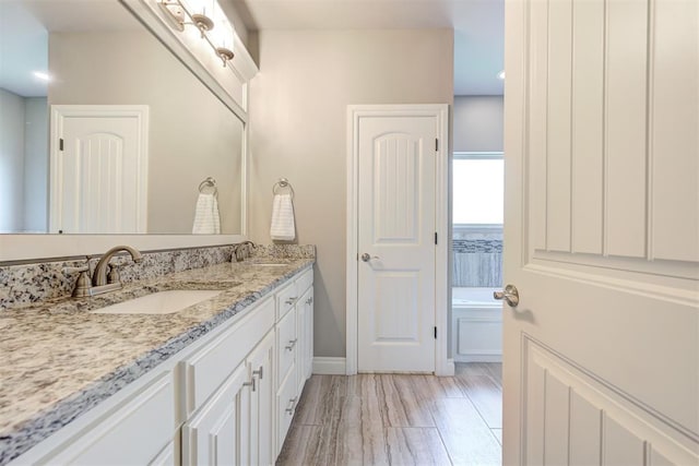 4600 Kentucky Ridge Dr, Mustang, OK 73064 - full bathroom featuring double vanity, a bath, and wood finished floors