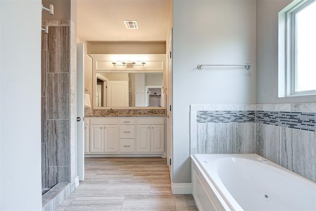 4600 Kentucky Ridge Dr, Mustang, OK 73064 - full bath featuring healthy amount of natural light, a tub with jets, double vanity, and a tile shower