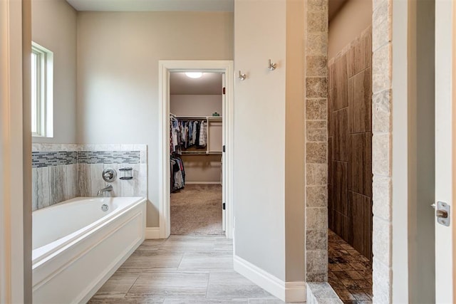 4600 Kentucky Ridge Dr, Mustang, OK 73064 - bathroom with a bath, tiled shower, and a spacious closet