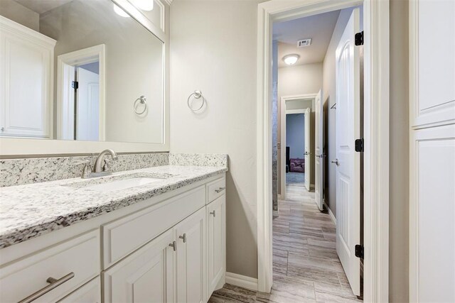 4600 Kentucky Ridge Dr, Mustang, OK 73064 - bathroom featuring vanity and wood finished floors