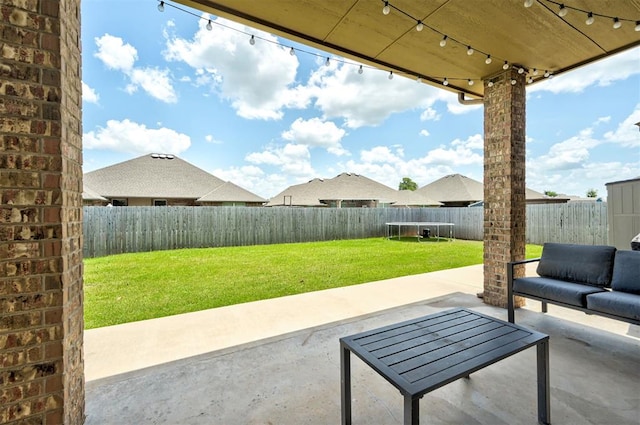 4600 Kentucky Ridge Dr, Mustang, OK 73064 - fenced backyard featuring a trampoline, a patio, and an outdoor living space
