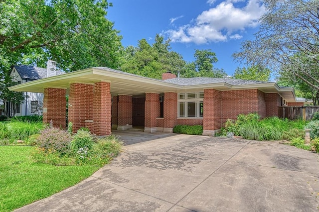823 S Flood Ave, Norman, OK 73069 - ranch-style home featuring driveway, brick siding, a chimney, and a carport