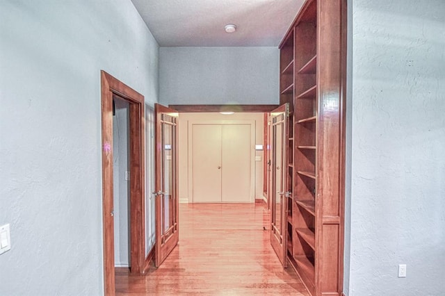 823 S Flood Ave, Norman, OK 73069 - hall with light wood finished floors and a textured wall