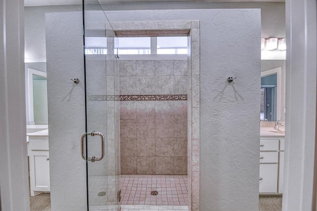 823 S Flood Ave, Norman, OK 73069 - bathroom with a textured wall, vanity, and a shower stall