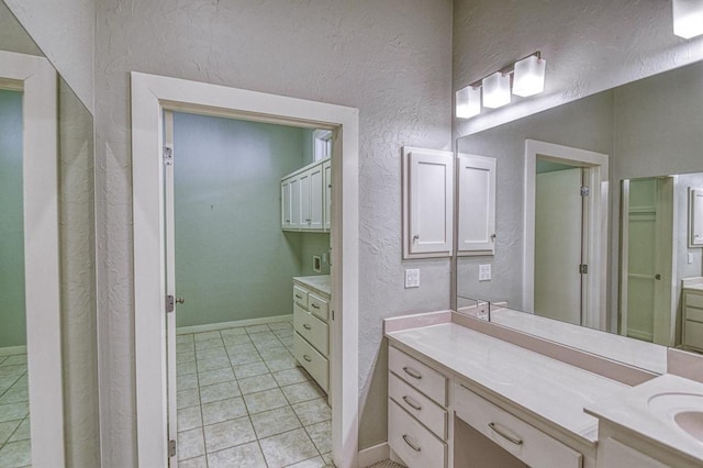 823 S Flood Ave, Norman, OK 73069 - bathroom with vanity, a textured wall, and tile patterned flooring