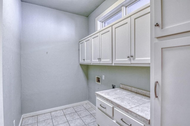 823 S Flood Ave, Norman, OK 73069 - washroom with hookup for an electric dryer, cabinet space, hookup for a washing machine, and light tile patterned floors