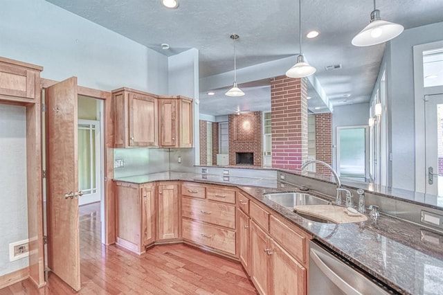 823 S Flood Ave, Norman, OK 73069 - kitchen featuring light wood-type flooring, stainless steel dishwasher, dark stone counters, pendant lighting, and light brown cabinetry