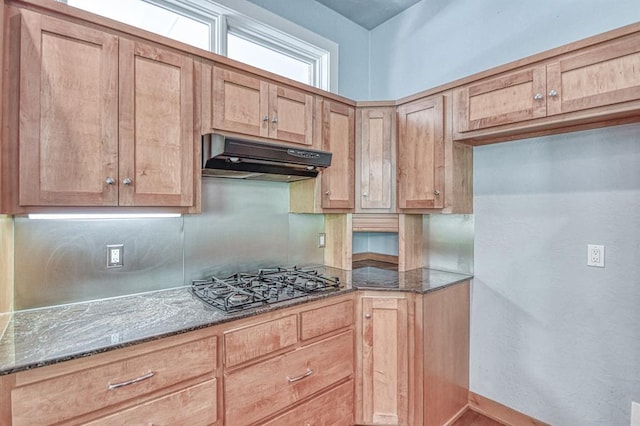 823 S Flood Ave, Norman, OK 73069 - kitchen with black gas cooktop, under cabinet range hood, dark stone countertops, and light brown cabinets