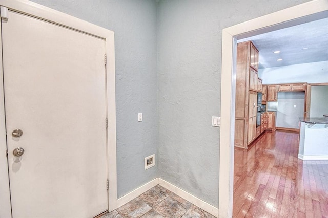 823 S Flood Ave, Norman, OK 73069 - laundry area with a textured wall and hardwood / wood-style flooring