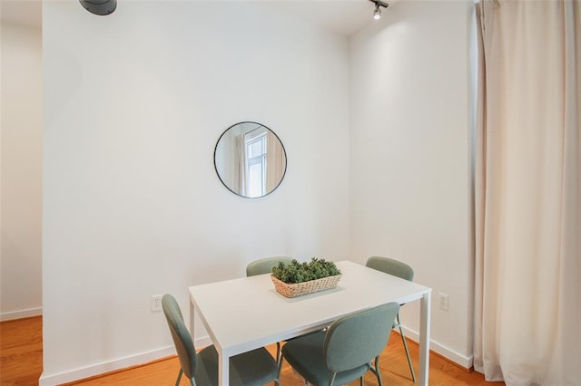 1 NE 2nd St Unit 402, Oklahoma City, OK 73104 - dining space featuring baseboards and light wood-style flooring