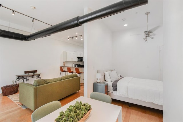 1 NE 2nd St Unit 402, Oklahoma City, OK 73104 - bedroom featuring rail lighting, light wood-type flooring, and recessed lighting