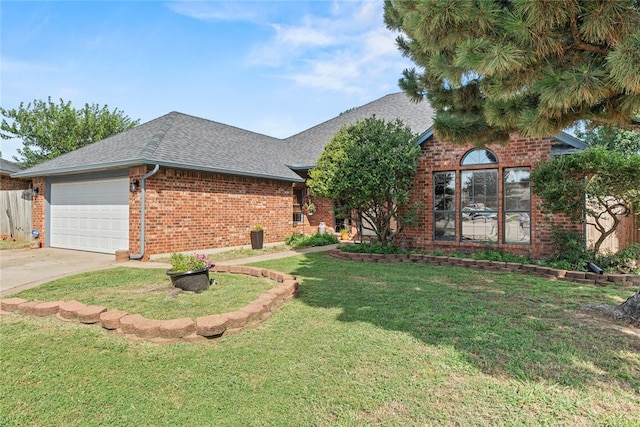 4924 Byron Cir, Yukon, OK 73099 - view of front of house with brick siding, a shingled roof, an attached garage, concrete driveway, and a front lawn