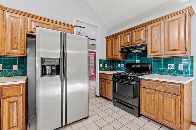 4924 Byron Cir, Yukon, OK 73099 - kitchen featuring stainless steel refrigerator with ice dispenser, black range with gas stovetop, under cabinet range hood, light countertops, and lofted ceiling