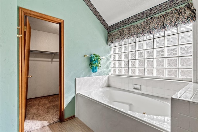4924 Byron Cir, Yukon, OK 73099 - full bathroom featuring a bath, wood finished floors, and a walk in closet