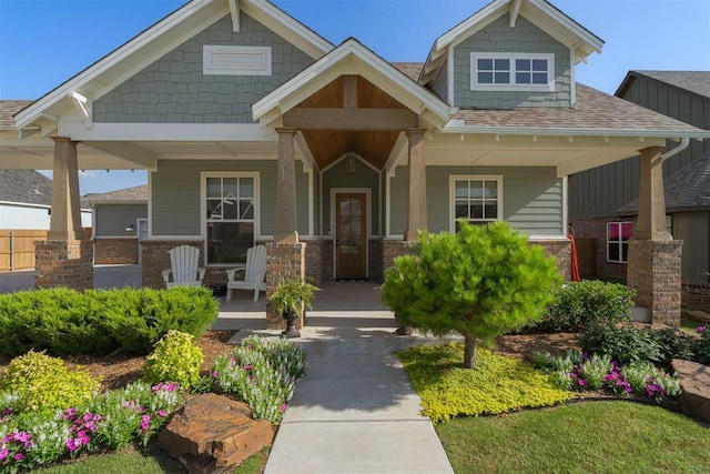 3624 Utica Square Dr, Edmond, OK 73034 - craftsman-style home with a porch and roof with shingles