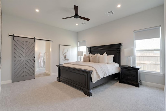 3624 Utica Square Dr, Edmond, OK 73034 - bedroom with a barn door, light colored carpet, multiple windows, and recessed lighting