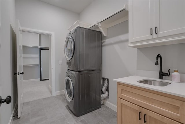 3624 Utica Square Dr, Edmond, OK 73034 - laundry area featuring estacked washer and dryer and cabinet space