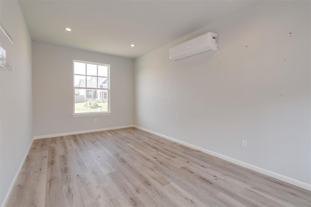 3624 Utica Square Dr, Edmond, OK 73034 - spare room with a wall mounted AC, light wood-style floors, and recessed lighting
