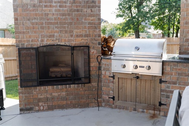 3624 Utica Square Dr, Edmond, OK 73034 - view of patio with an outdoor brick fireplace and grilling area
