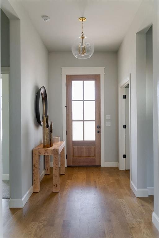 3624 Utica Square Dr, Edmond, OK 73034 - doorway to outside featuring light wood-style floors and a chandelier