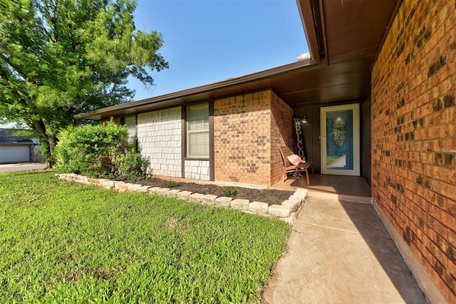 1229 S Gemini Rd, Edmond, OK 73003 - doorway to property featuring brick siding and a yard