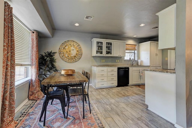 1229 S Gemini Rd, Edmond, OK 73003 - kitchen with dishwasher, light wood-style floors, white cabinets, glass insert cabinets, and light stone counters