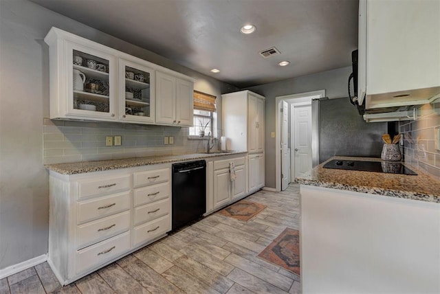 1229 S Gemini Rd, Edmond, OK 73003 - kitchen featuring black appliances, white cabinets, glass insert cabinets, light stone countertops, and recessed lighting