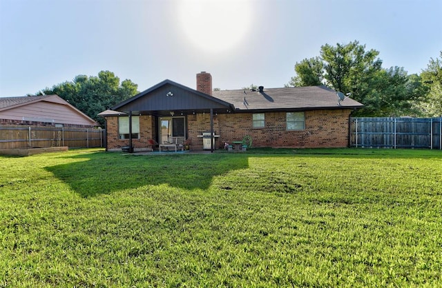1229 S Gemini Rd, Edmond, OK 73003 - rear view of property featuring a patio area, brick siding, and a fenced backyard
