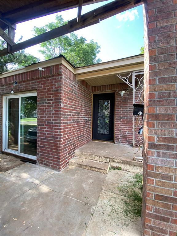 2451 NW 42nd St, Oklahoma City, OK 73112 - property entrance with brick siding