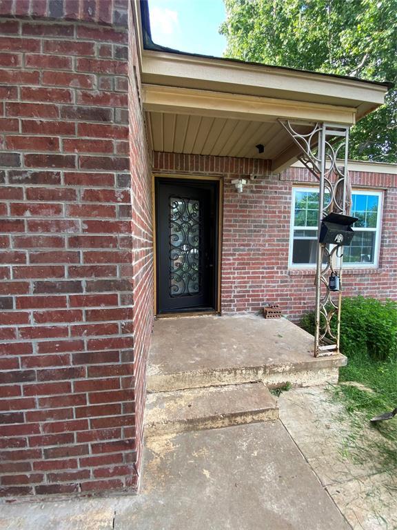2451 NW 42nd St, Oklahoma City, OK 73112 - property entrance featuring brick siding