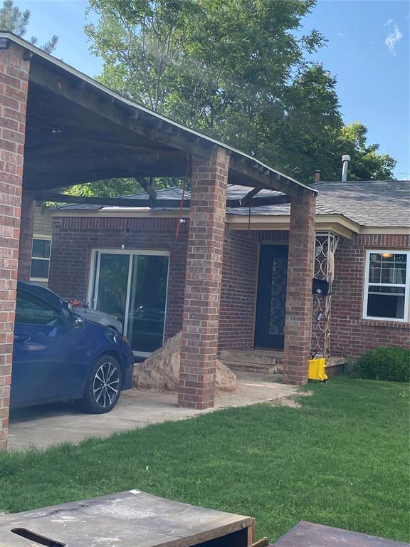 2451 NW 42nd St, Oklahoma City, OK 73112 - view of front of home with a front yard and brick siding