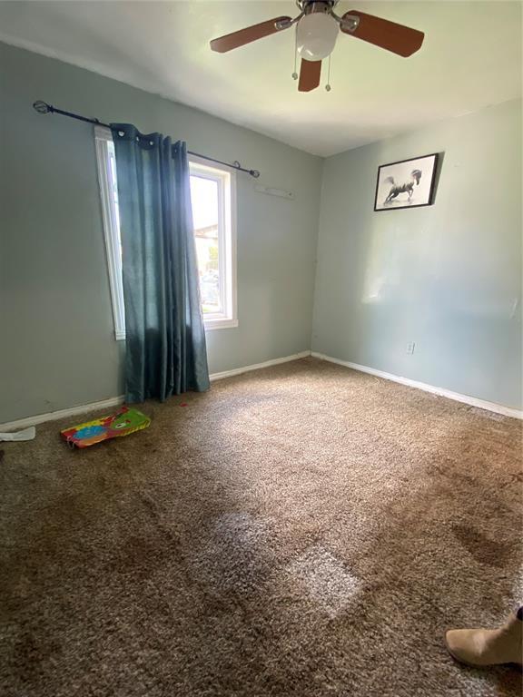 2451 NW 42nd St, Oklahoma City, OK 73112 - carpeted spare room featuring ceiling fan and baseboards