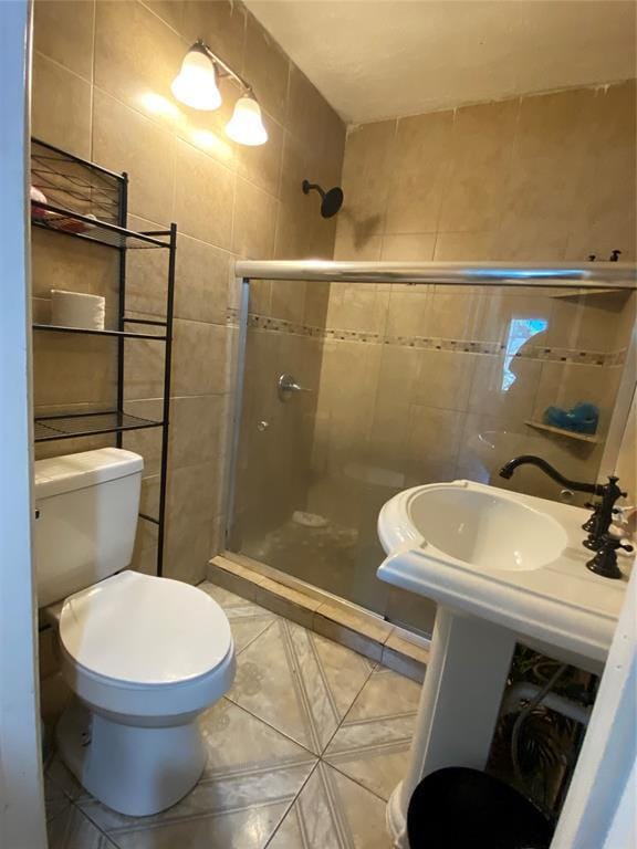 2451 NW 42nd St, Oklahoma City, OK 73112 - full bath with tile walls, a shower stall, and tile patterned flooring