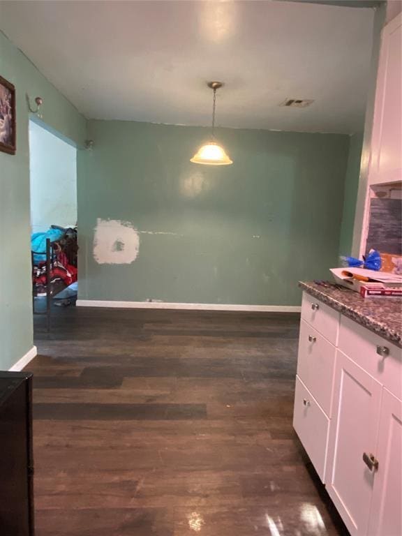 2451 NW 42nd St, Oklahoma City, OK 73112 - dining room with baseboards and dark wood finished floors