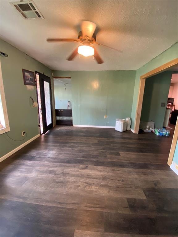 2451 NW 42nd St, Oklahoma City, OK 73112 - unfurnished living room featuring a ceiling fan, wood finished floors, and a textured ceiling