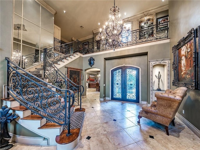 12912 Anduin Ave, Oklahoma City, OK 73170 - tiled foyer entrance with arched walkways, a high ceiling, a chandelier, stairway, and crown molding