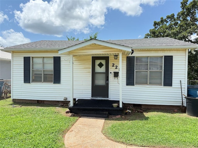221 N Iowa St, Chandler, OK 74834 - view of front facade featuring a front lawn and a shingled roof