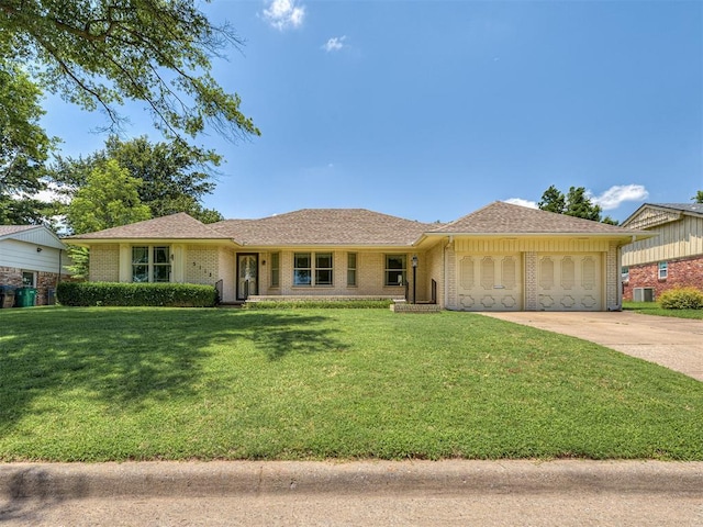 3113 Tudor Rd, Oklahoma City, OK 73122 - ranch-style home with an attached garage, concrete driveway, brick siding, and a front yard