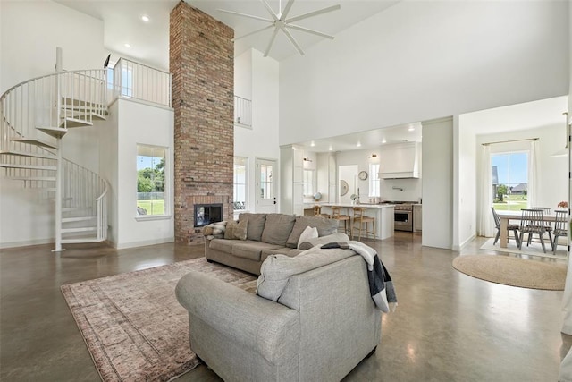 1006 Dorsi Way, Newcastle, OK 73065 - living room with finished concrete floors, a high ceiling, plenty of natural light, stairway, and a brick fireplace