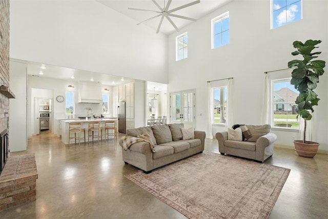 1006 Dorsi Way, Newcastle, OK 73065 - living room featuring concrete flooring, a towering ceiling, a fireplace, and a ceiling fan