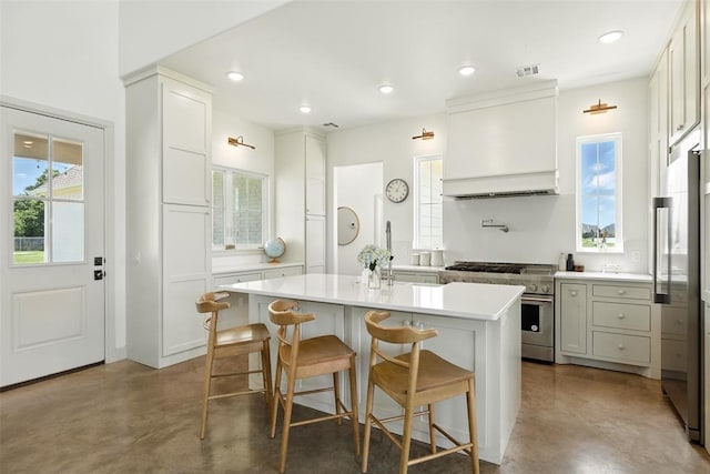 1006 Dorsi Way, Newcastle, OK 73065 - kitchen featuring high end stainless steel range, concrete floors, custom range hood, light countertops, and a center island
